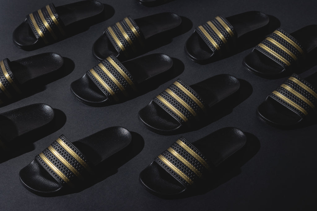 Adidas adilette clearance gold and black